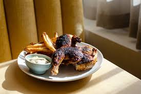 Baleia signature dishes Piri Piri ChickenWood-Grilled Whole FishPatatas Bravas